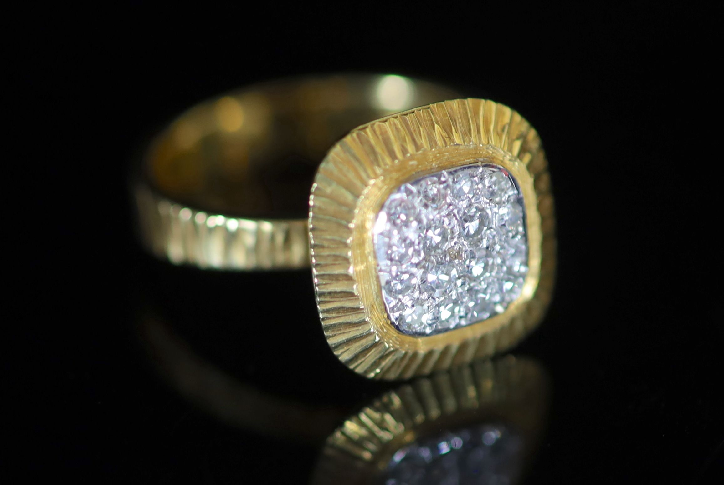 A modern 18ct gold and pave set diamond square cluster ring